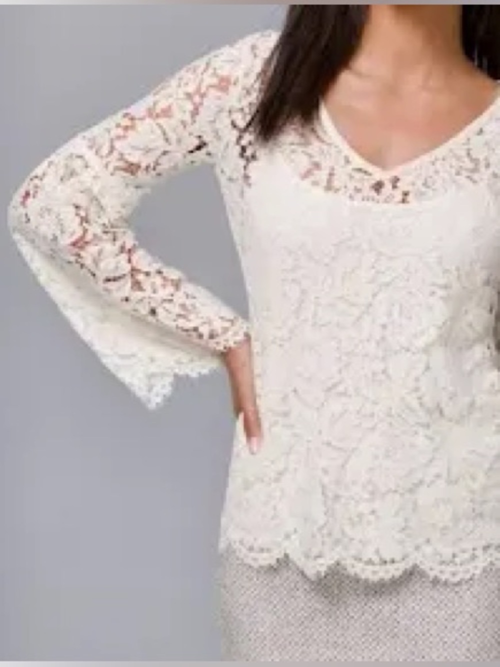 White House Black Market an ivory floral lace V-neck blouse. Size XS
